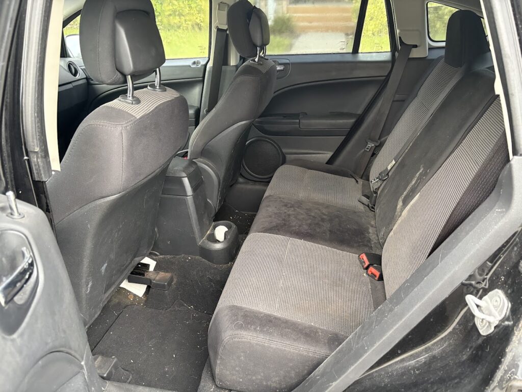 Back seat of a 2010 Dodge Caliber before interior detailing